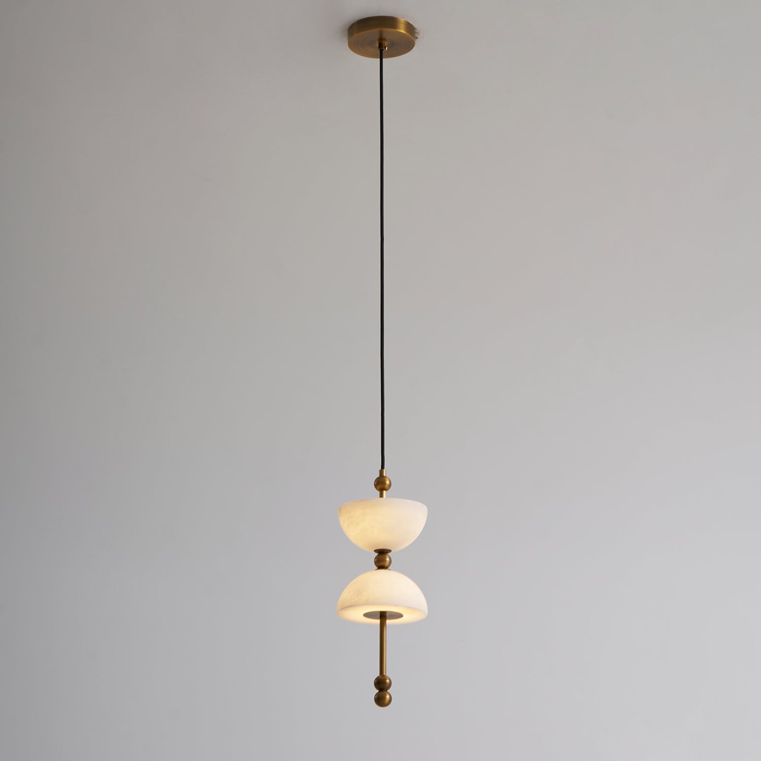 The lamp installed in a high-ceiling entryway.