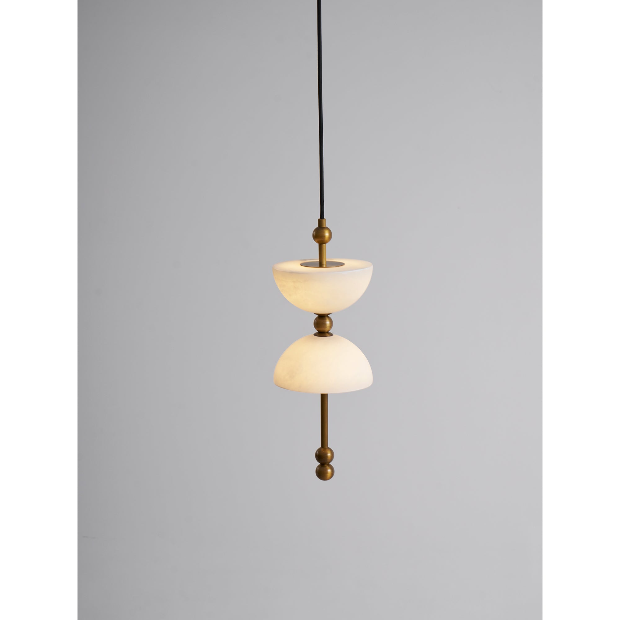 The ceiling canopy of the Lyra Chandelier in a brushed brass finish.
