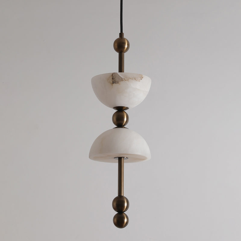 The polished brass body of the lamp reflecting its surroundings.