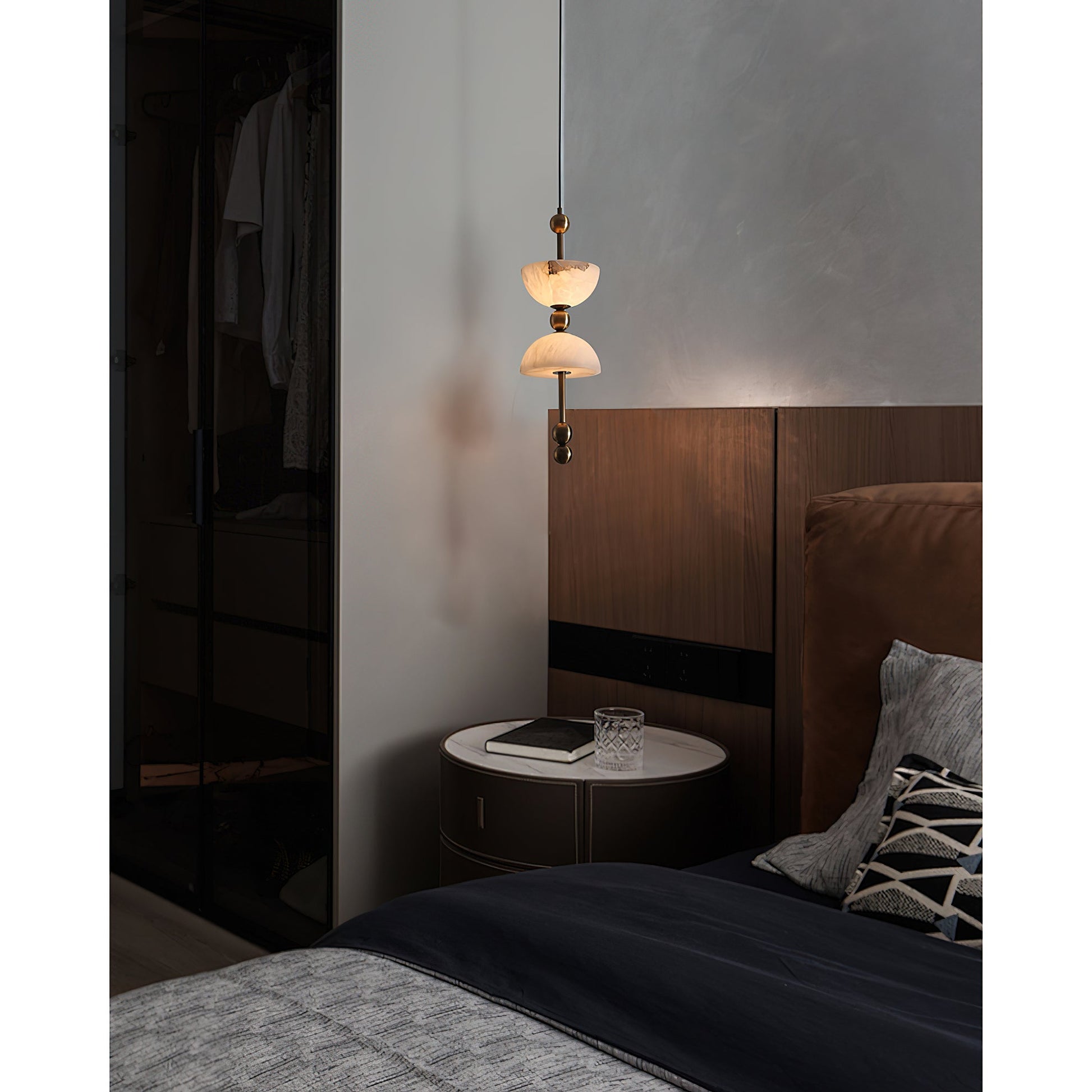 Lyra Alabaster Pendant Lamp against a dark, dramatic background.