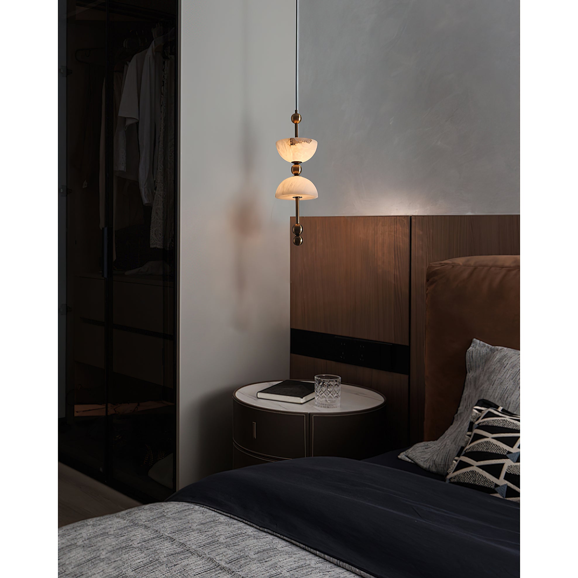 Lyra Alabaster Pendant Lamp against a dark, dramatic background.
