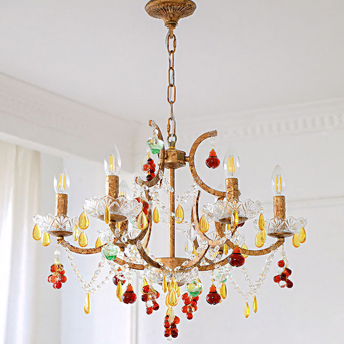 The chandelier hanging in a high-ceiling entryway.