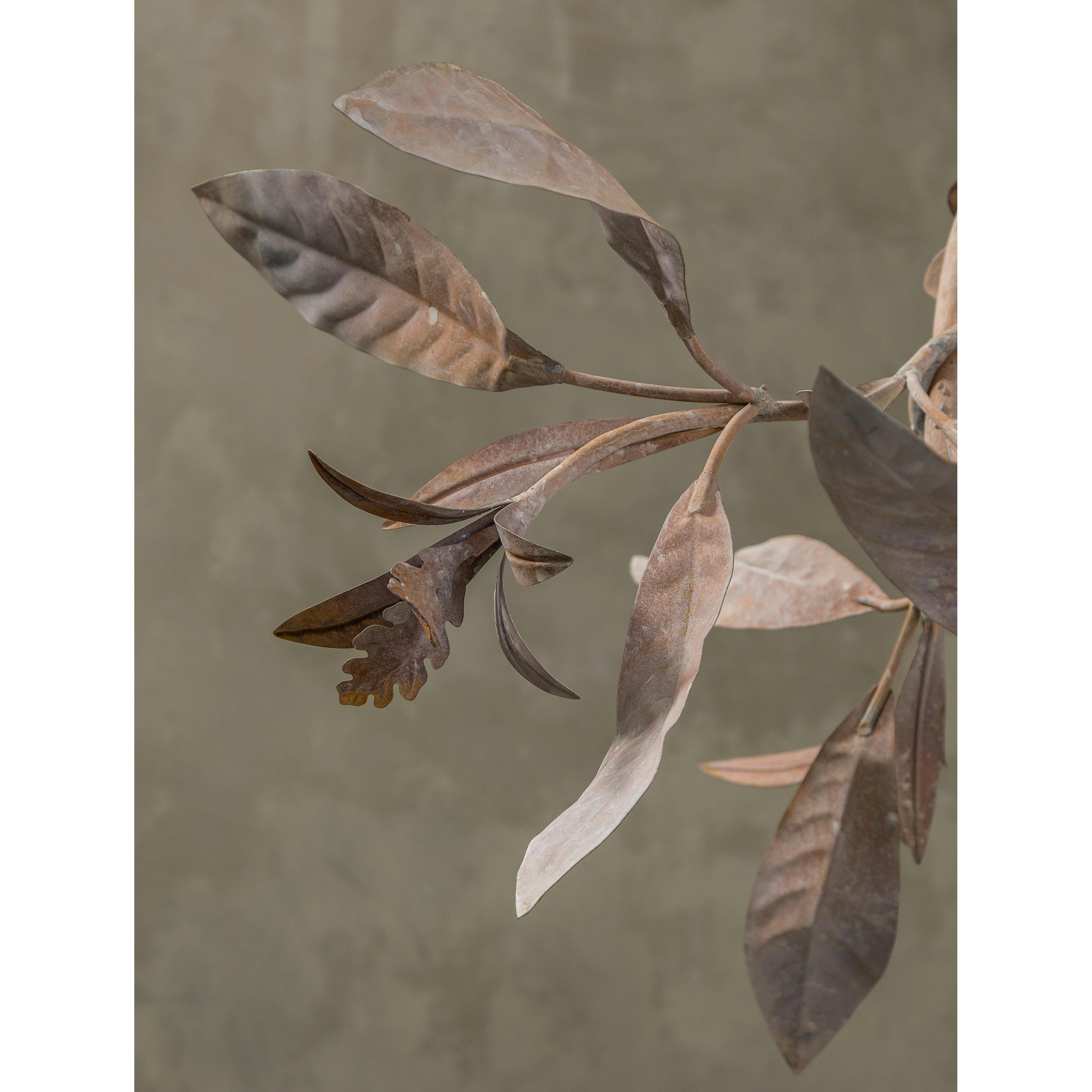 The chandelier against a dark wall, emphasizing the glowing effect of the blossoms.