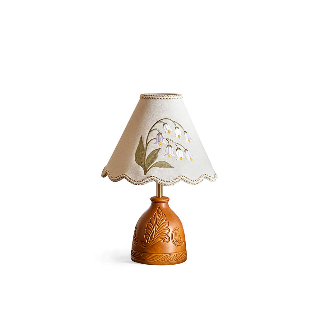 Maisie Table Lamp with carved wood base and floral embroidered shade.
