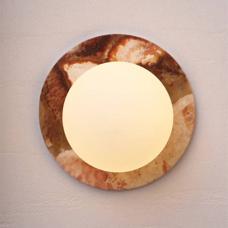 Minimalist white glass and marble wall lamp.