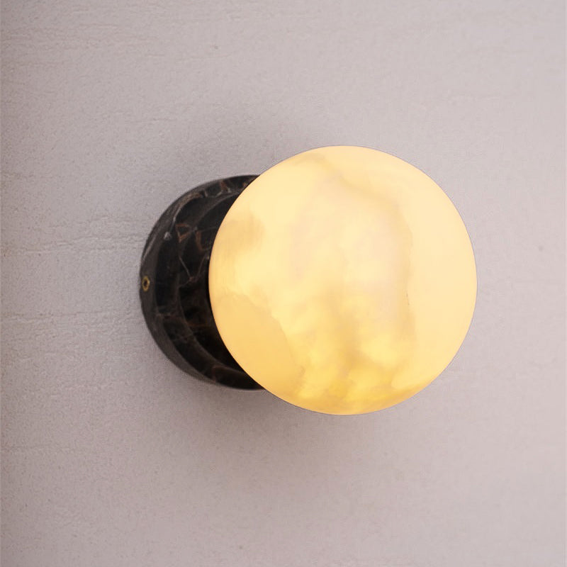 A collection of different stone wall lamps, including marble, travertine, and onyx.