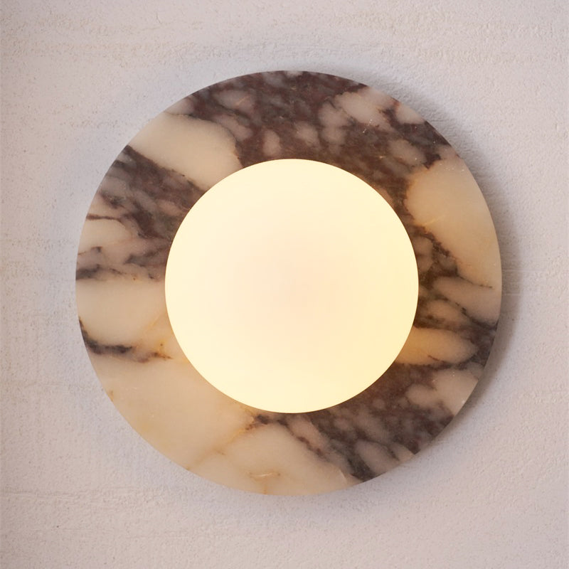 Brown marble wall lamp providing ambient light.