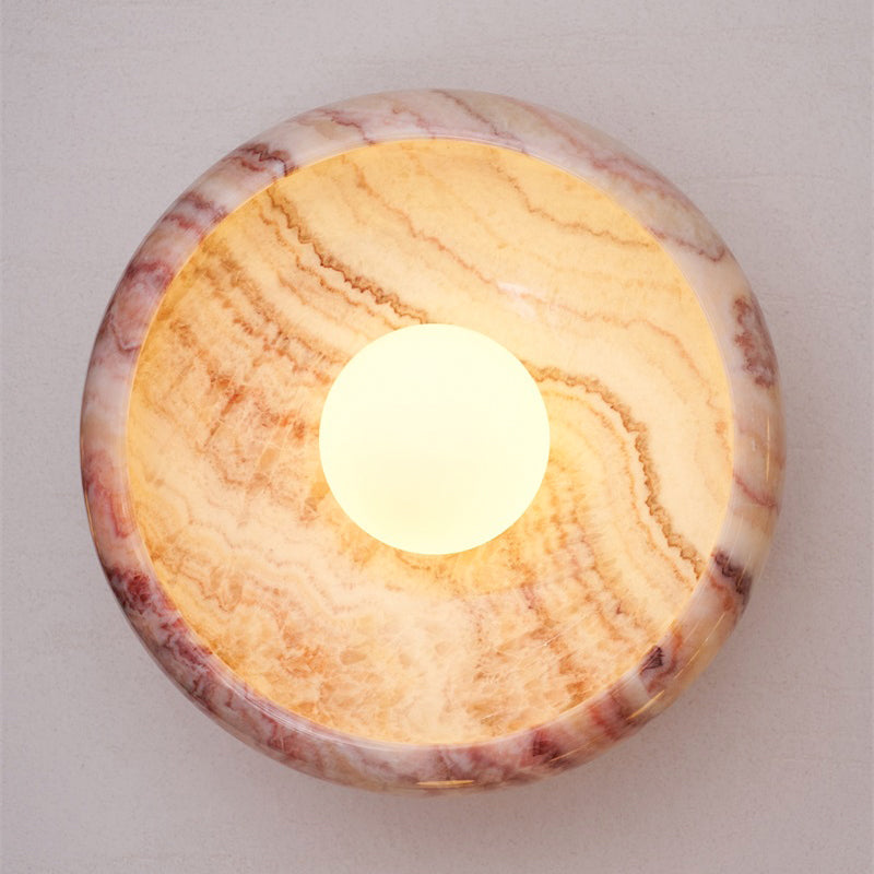 Red marble and brass wall lamp in a classic interior.