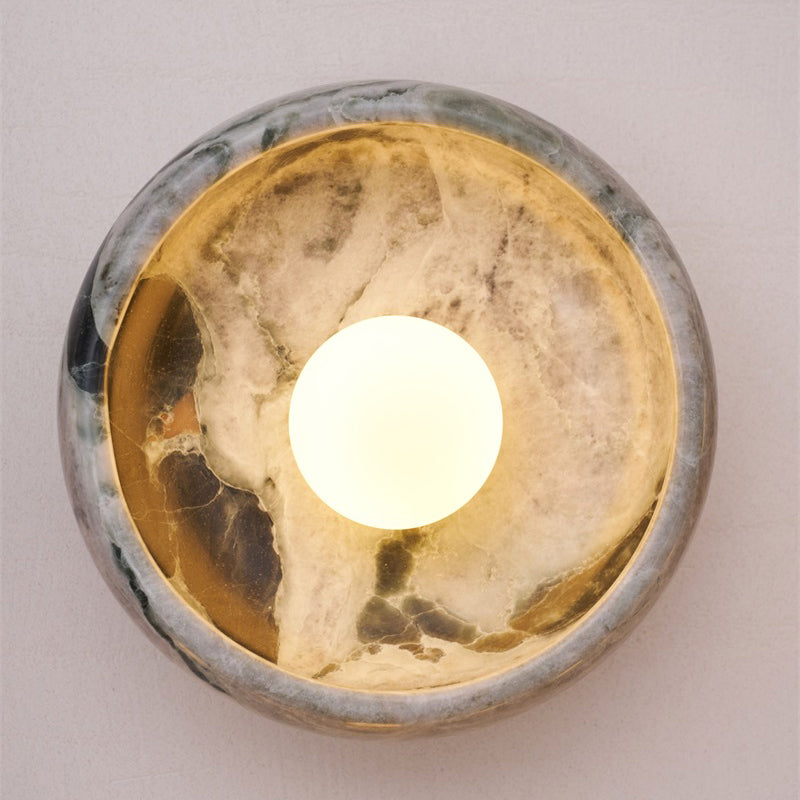 Side view of a travertine wall lamp.