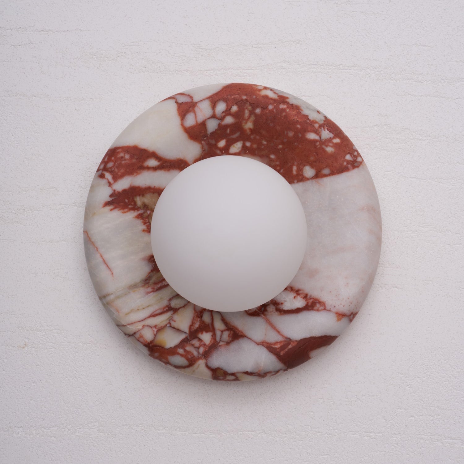 Pink and black marble wall lamp, showcasing the contrast.
