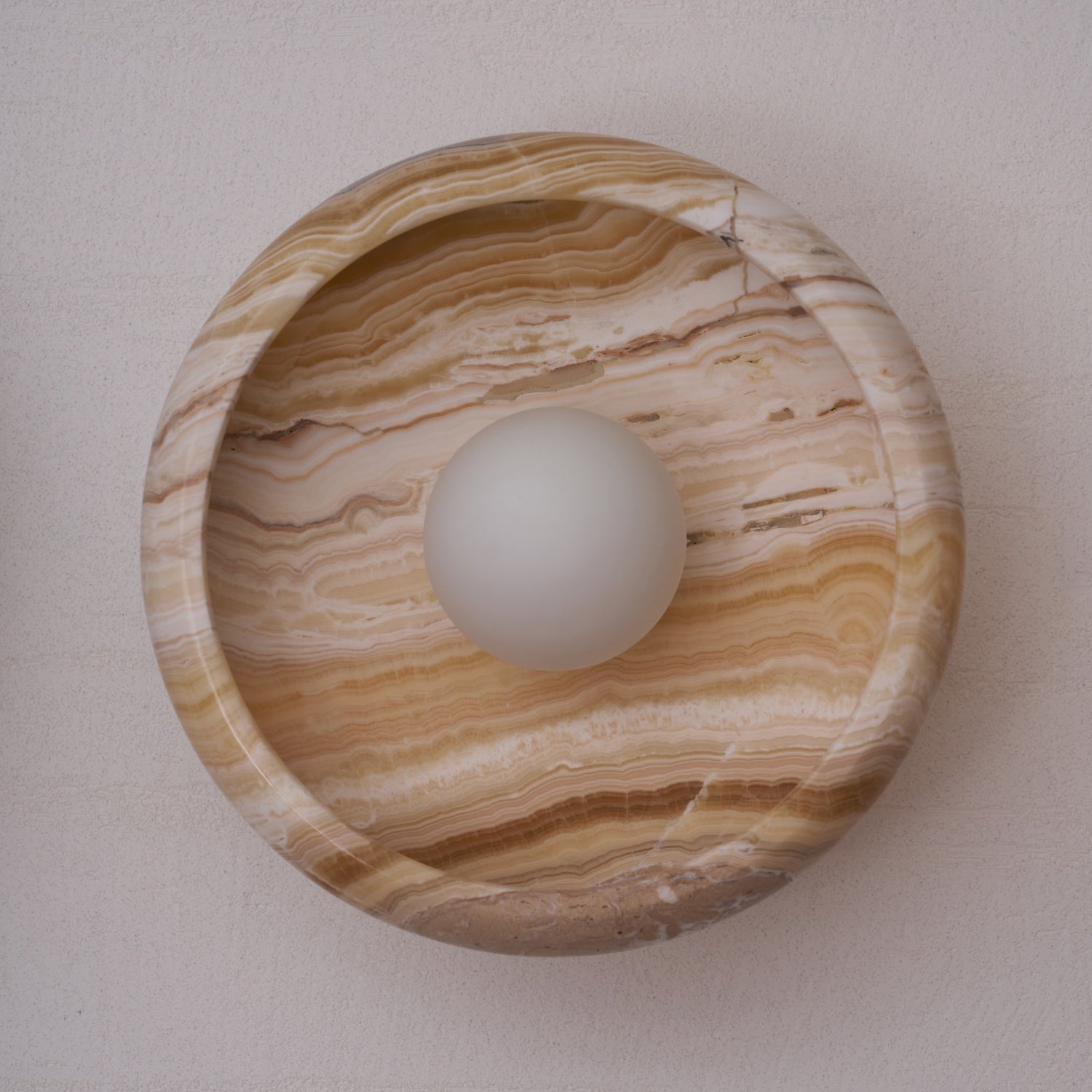 Violet red marble wall lamp in a dining area.