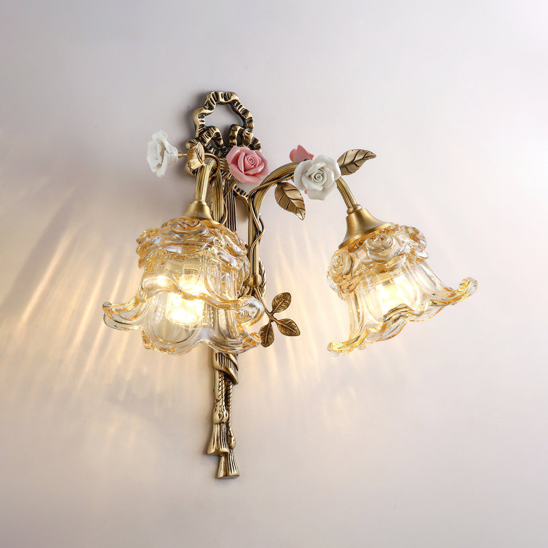The combination of the white ceramic flower and clear glass shade.