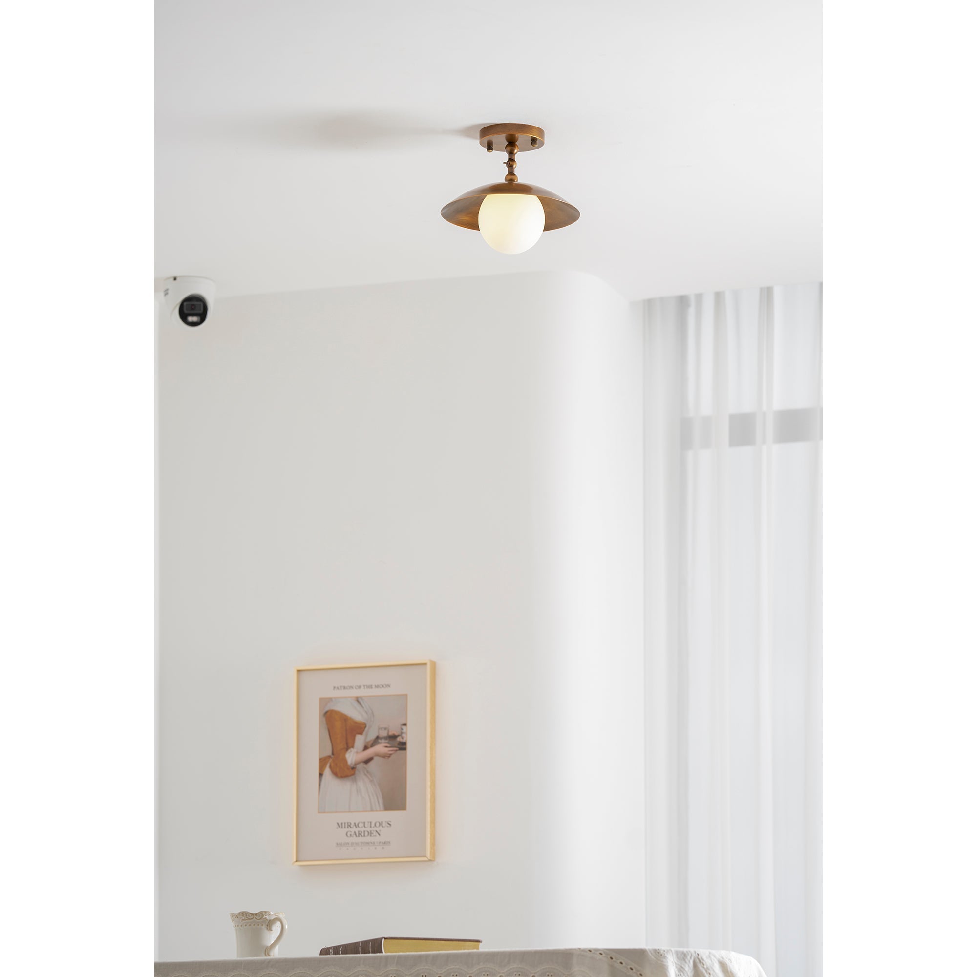Lifestyle image of the lamp in a cozy living room with mid-century decor.