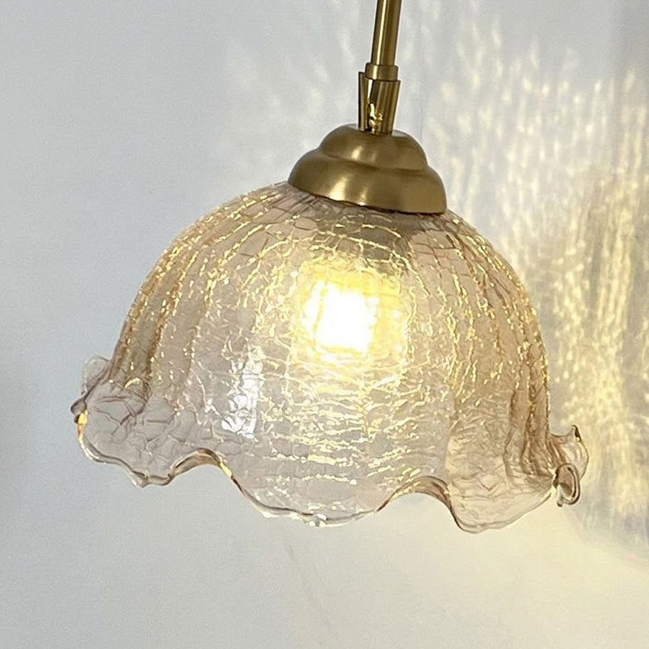 Detail of the connection between the glass shade and the brass arm.
