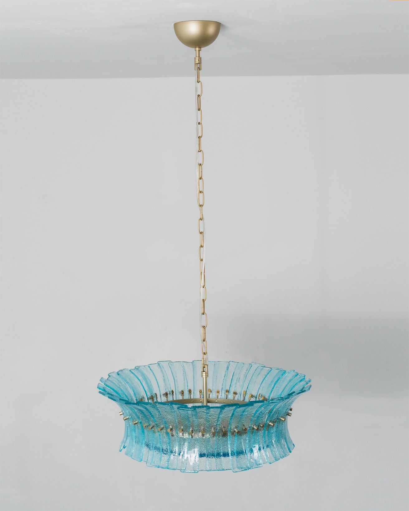 Close-up on the translucent aquamarine pigment of the glass.