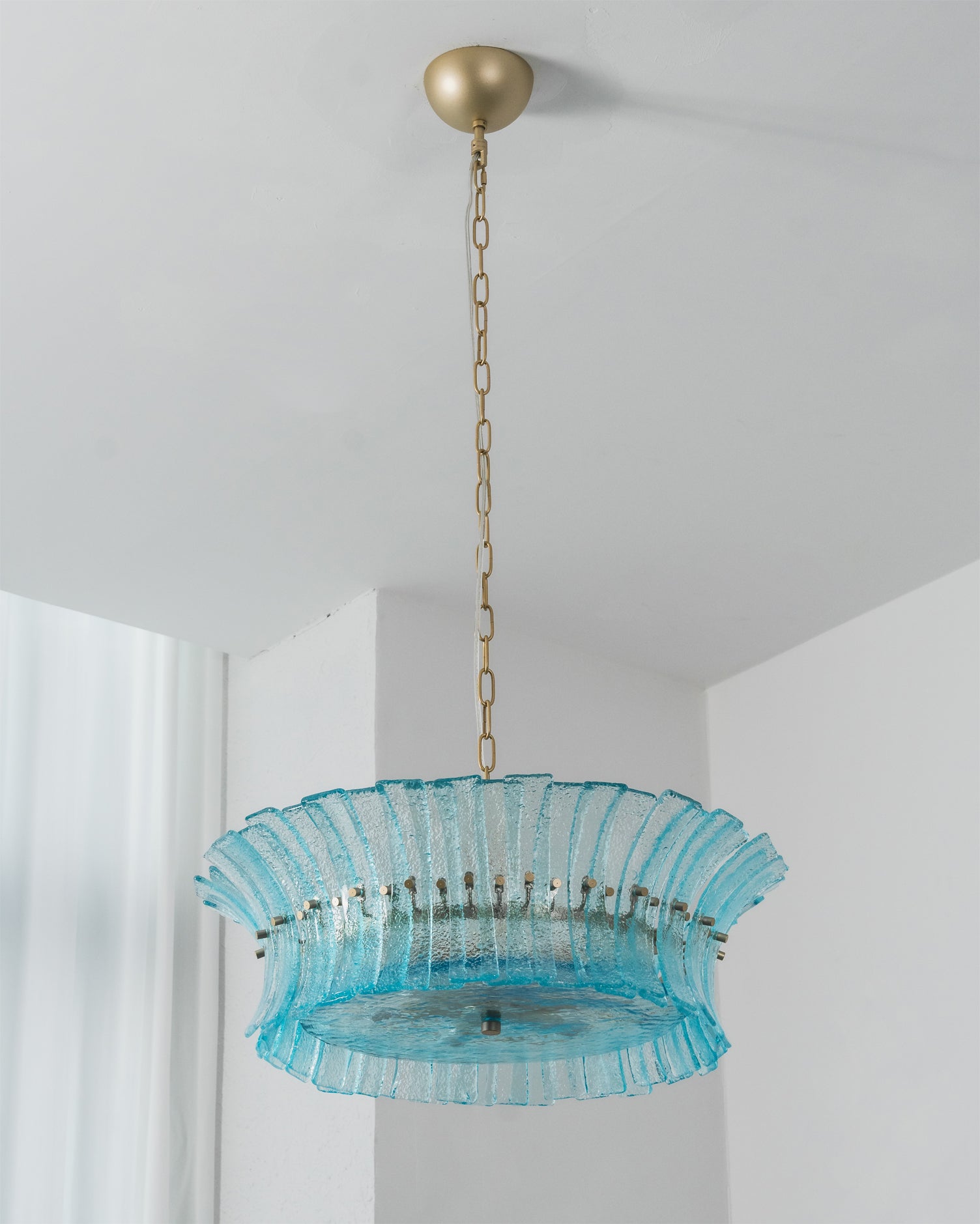 The Marin Chandelier casting light patterns on the ceiling.