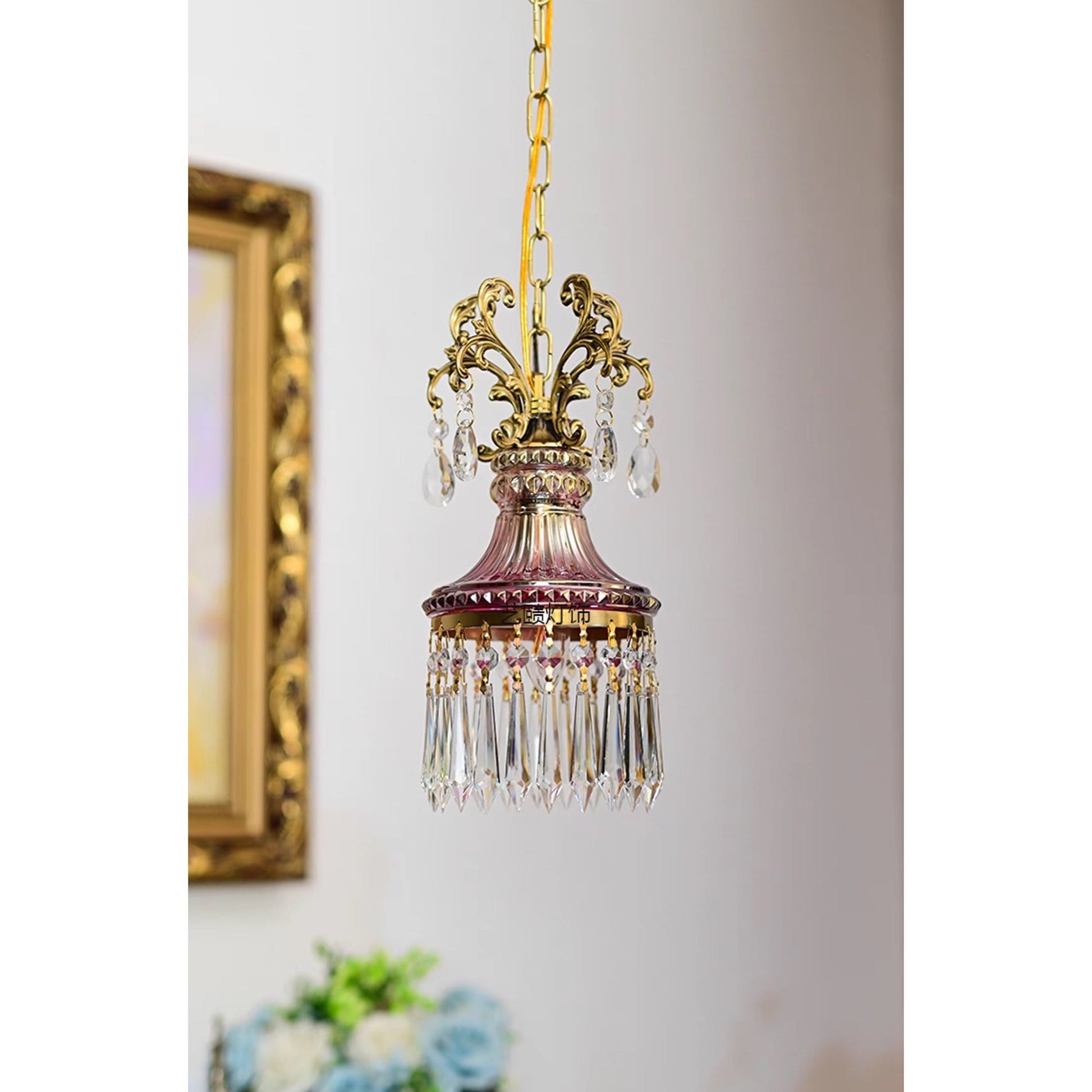 The pendant lamp illuminated, casting a warm glow through the crystal.