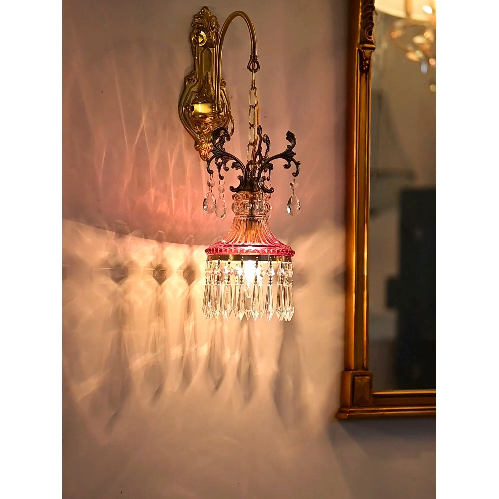 The Marquise Wall Lamp with an antique brass finish.