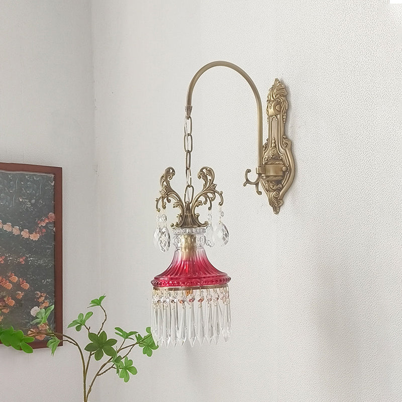 Full view of the red Marquise Crystal Wall Lamp against a dark wall.