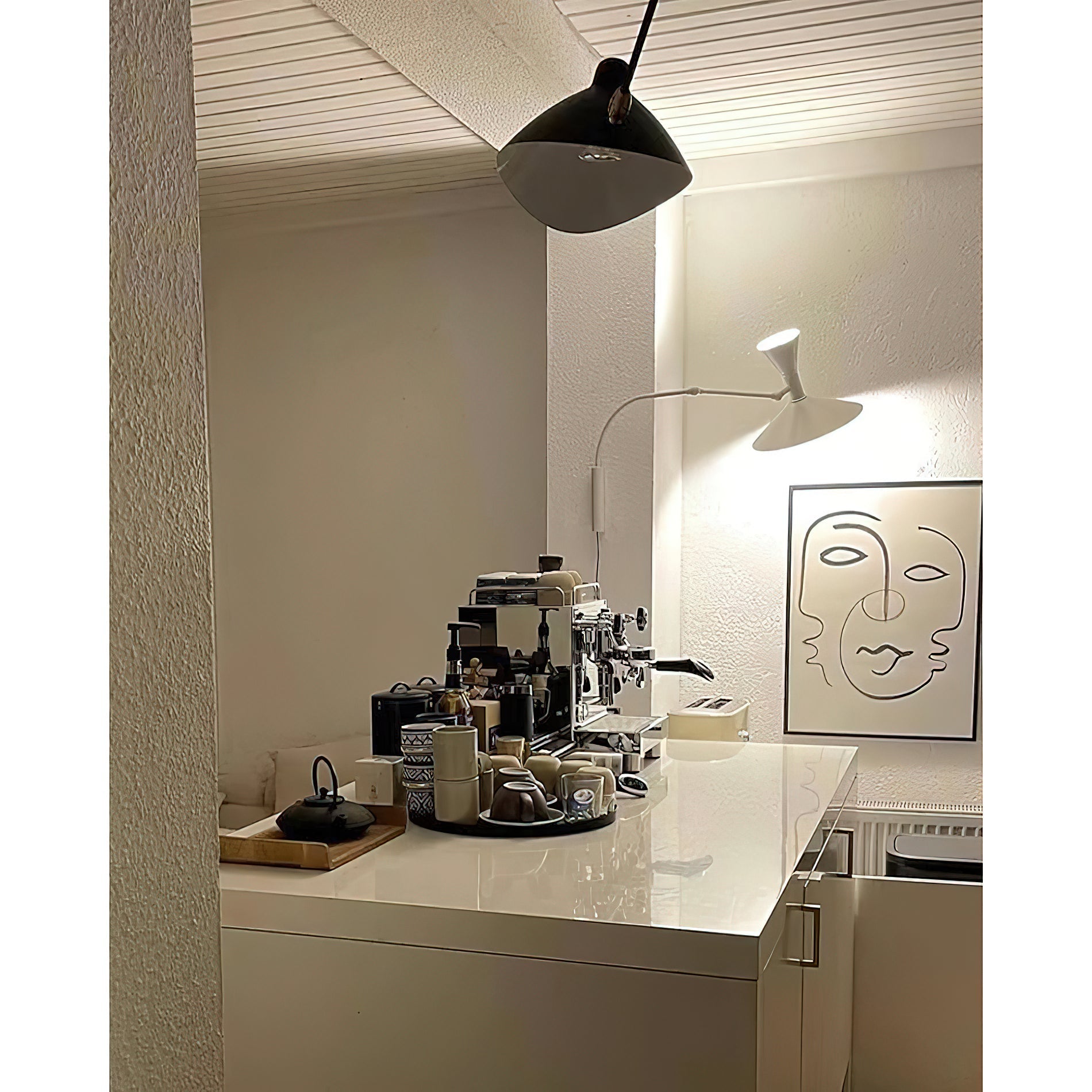 The grey sconce angled for task lighting over a desk.