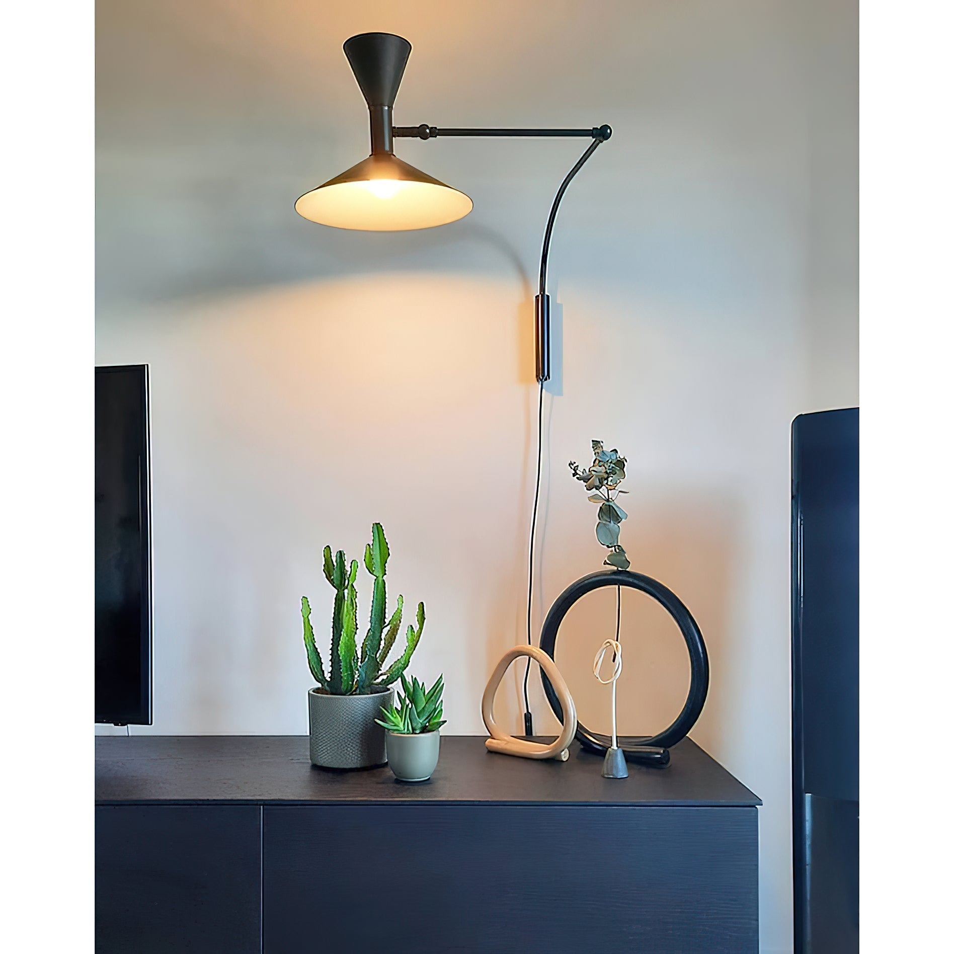 Lifestyle image of the black sconce in a modern living room.