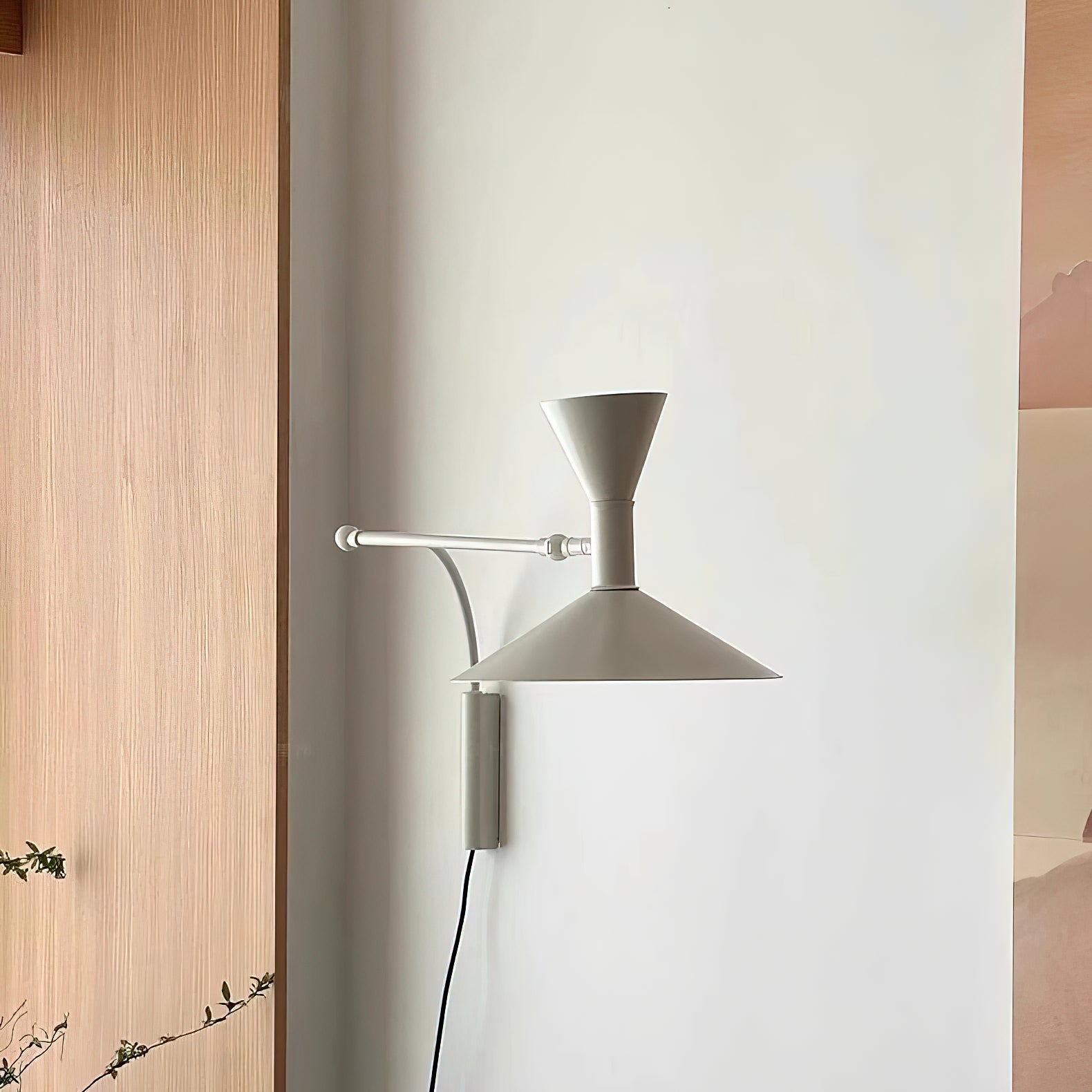 Detail shot of the white sconce's swivel mechanism.