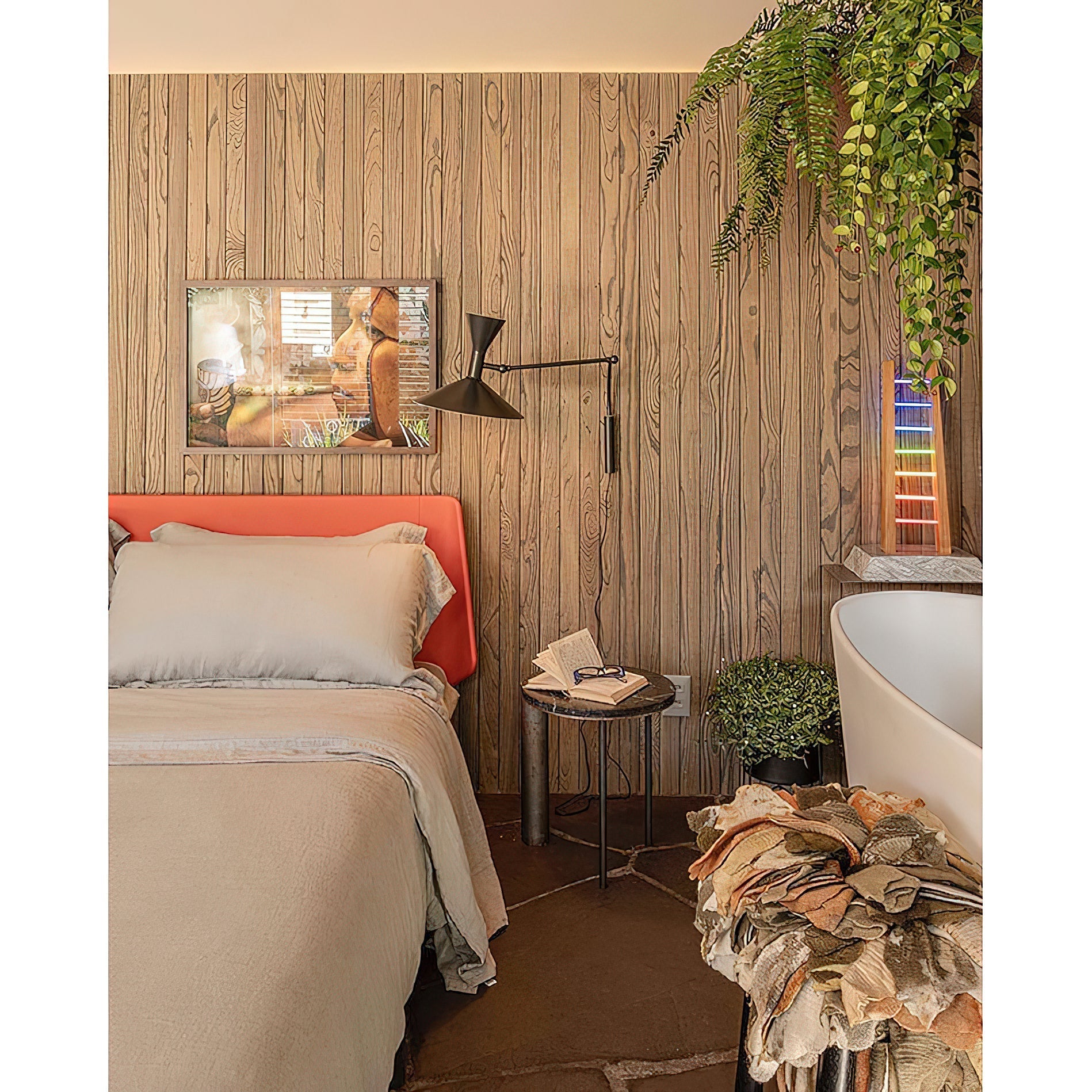 The white sconce mounted on a bedroom wall providing reading light.