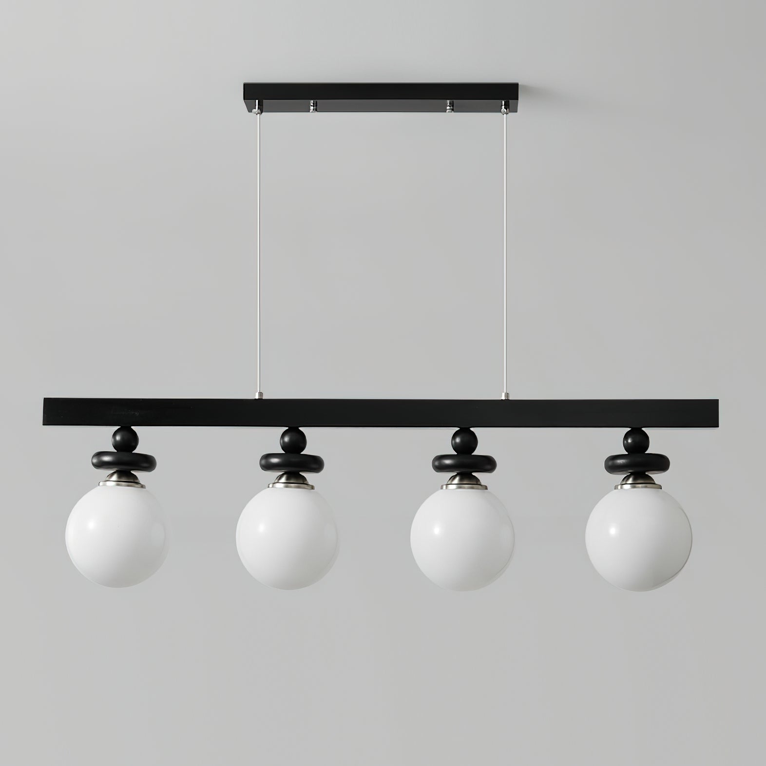 The 3-light Maru Pendant fixture against a clean, white wall.