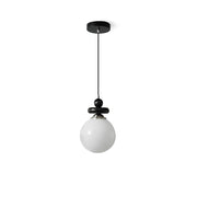 Maru Pendant Light with a ribbed glass globe and black metal frame.