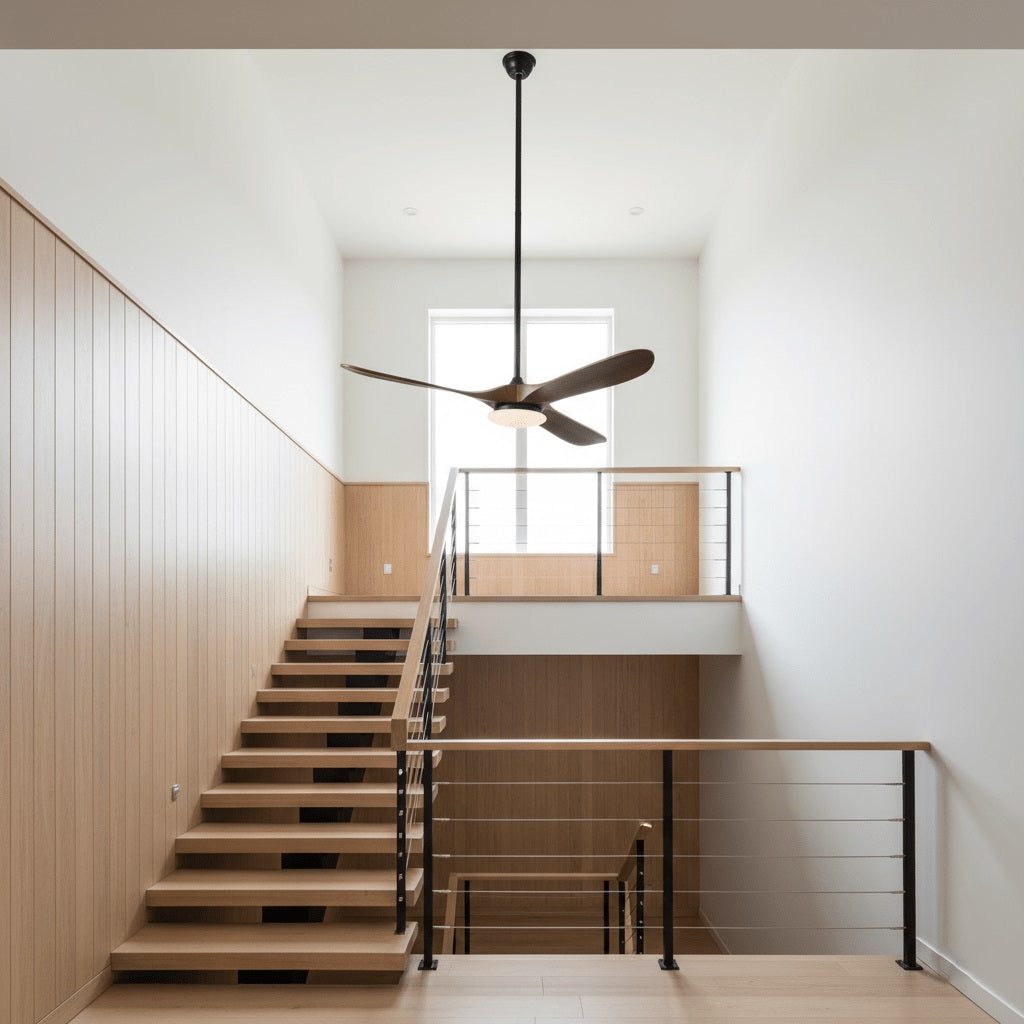 Angled view of the black Maverick ceiling fan with walnut blades in a living room setting.