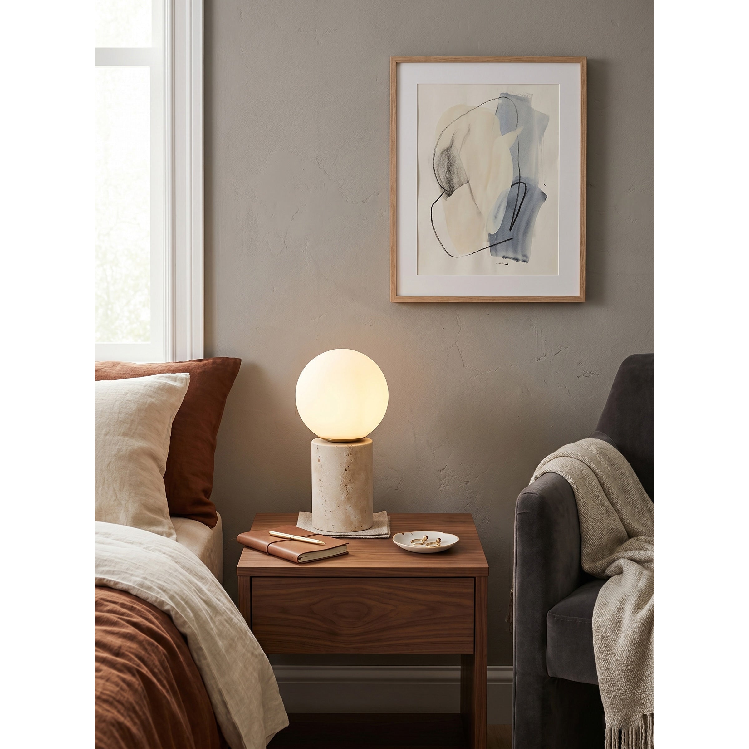 The travertine lamp placed on a sophisticated entryway console.