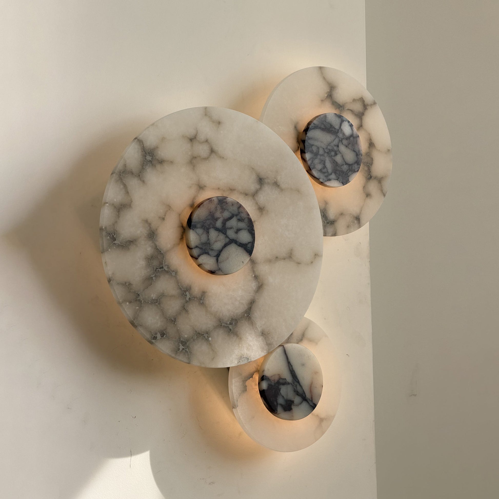 Close-up view of the alabaster and marble body of the Median Wall Lamp.