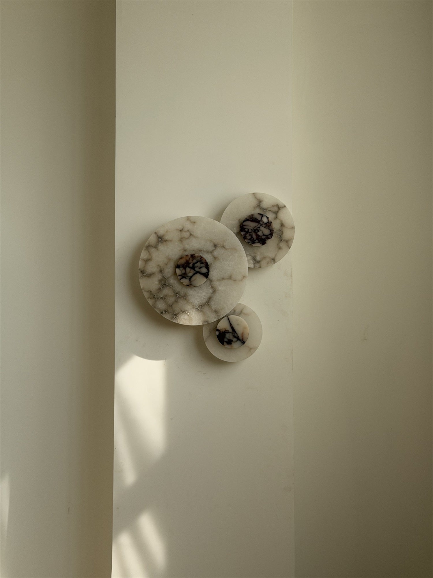 White Median Wall Lamp, unlit, showing material details.