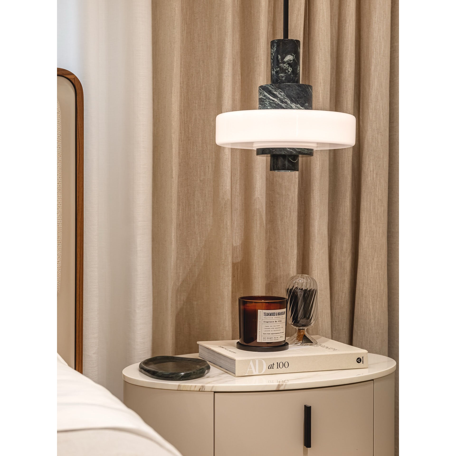 Two Mercury pendant lamps hanging side-by-side over a table.