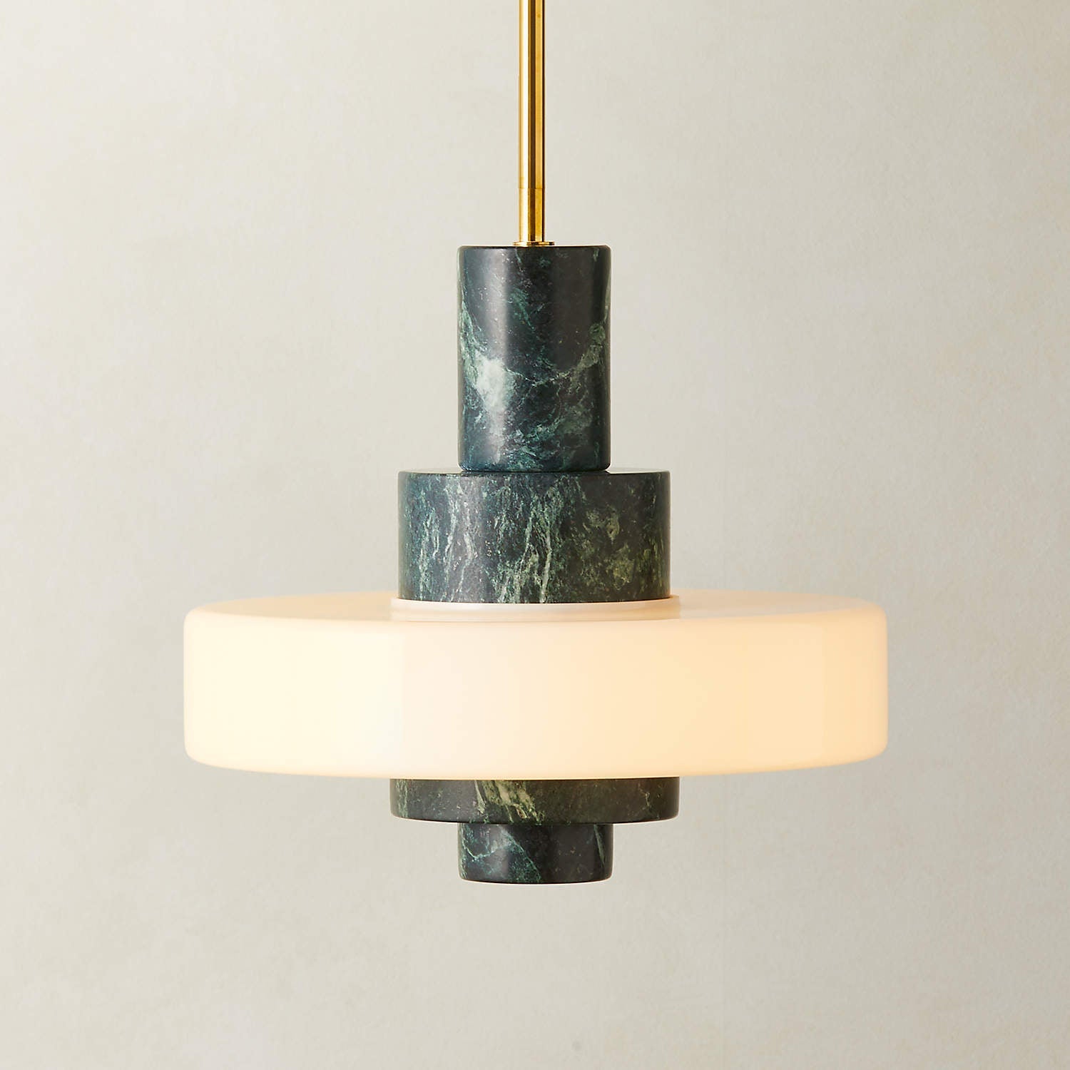 A deconstructed view showing the lamp's components: marble, glass, and brass.