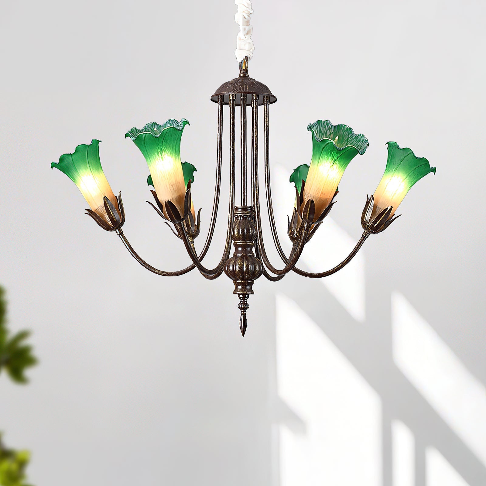 Meyda Chandelier lit up, casting a warm glow in a living room.