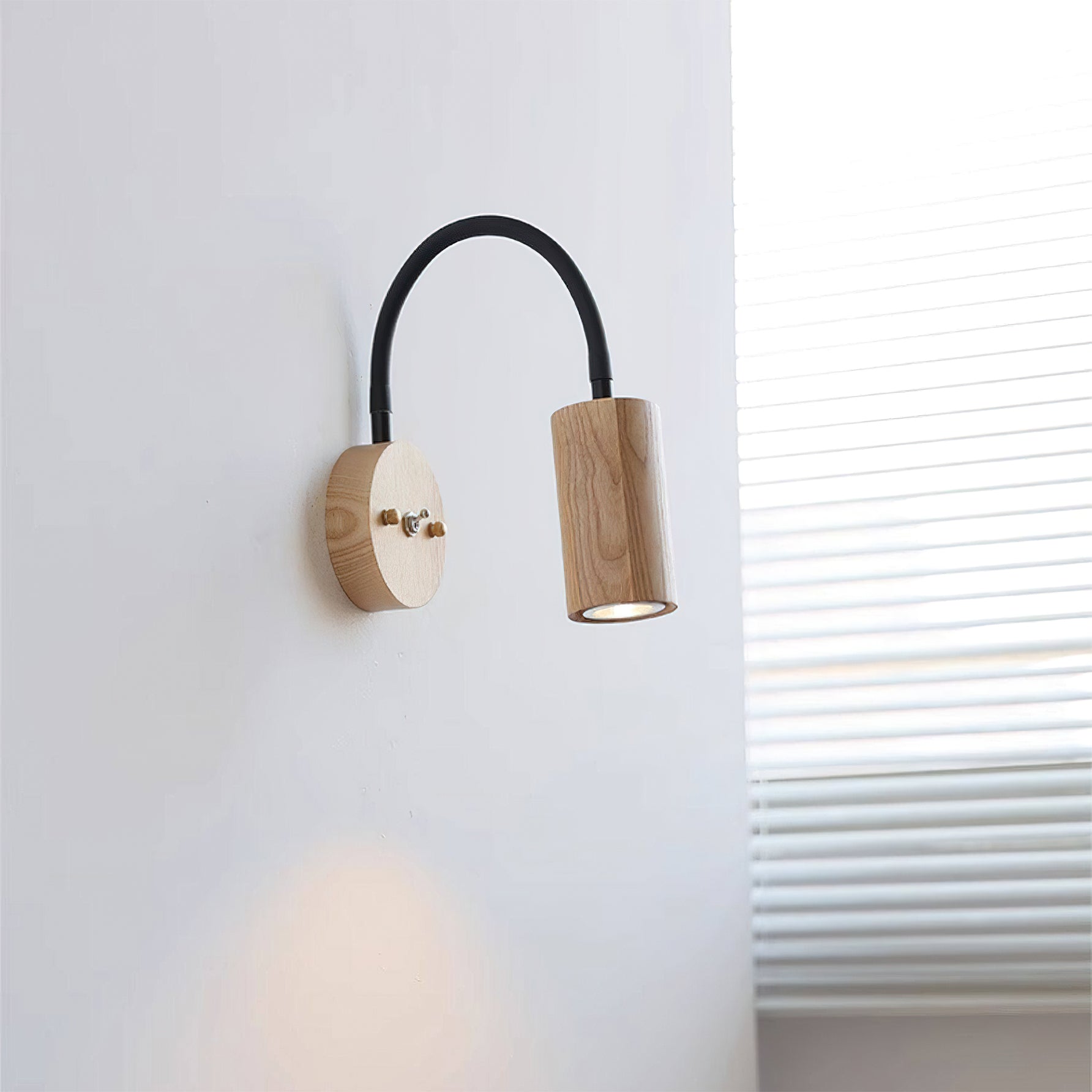 Side view of the Micro Wall Lamp showing the curved black arm.