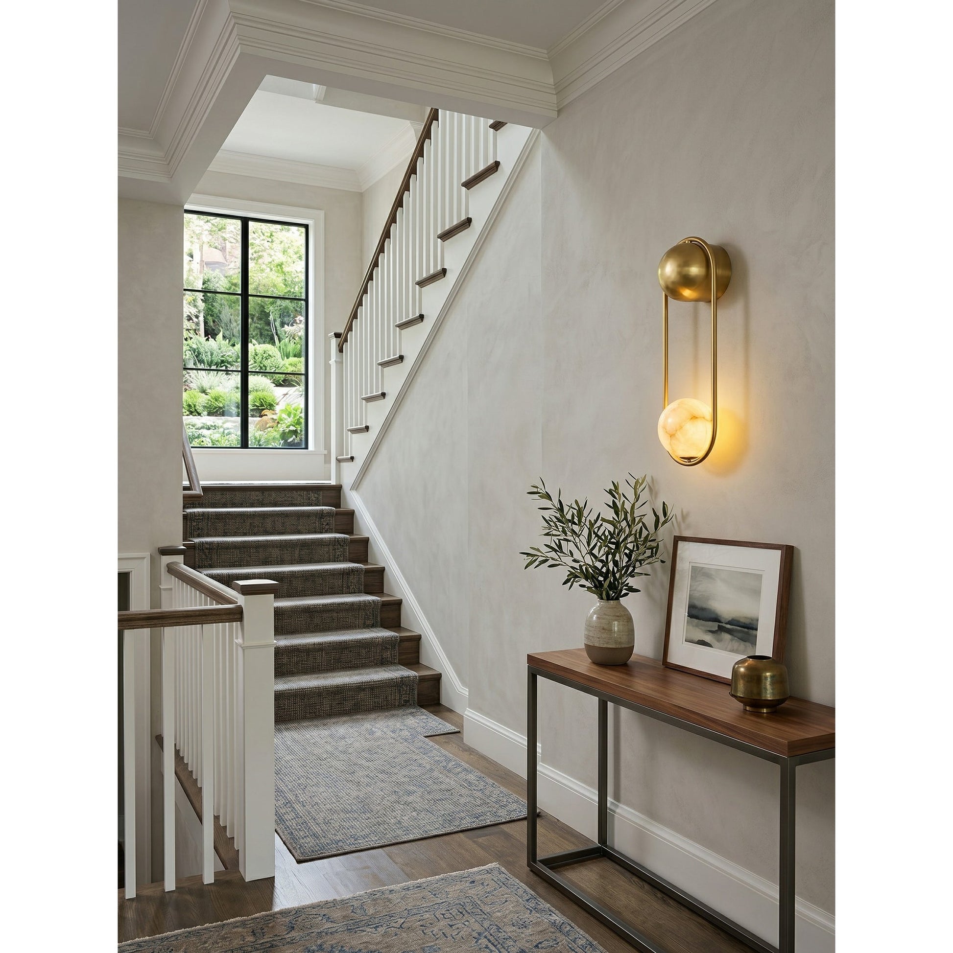 Angled view of the sconce highlighting its clean oval silhouette.