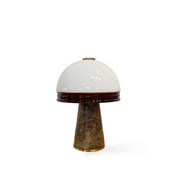 Milano Table Lamp with brown and white marble base and glowing opal glass orb.