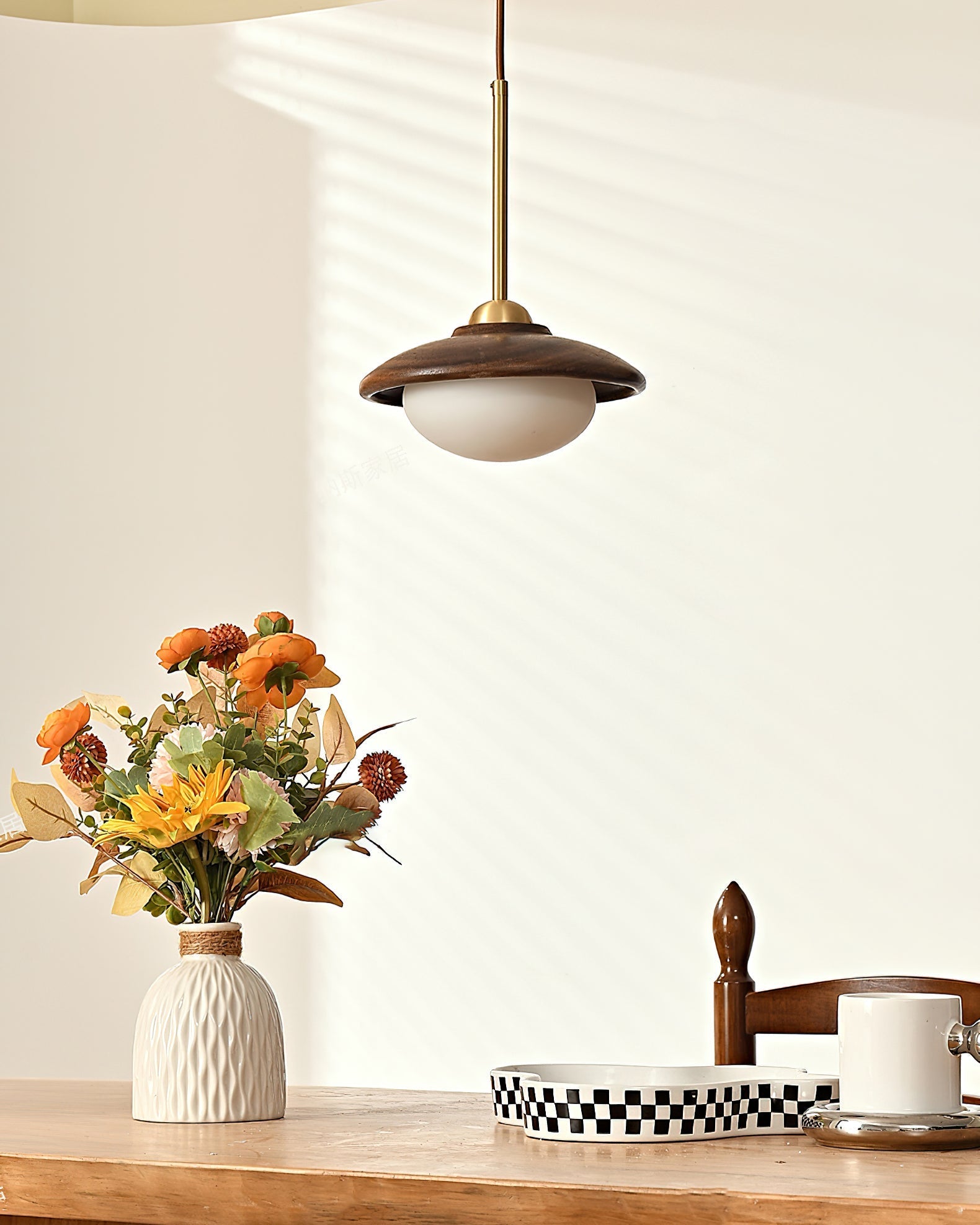 The Milivia Pendant Light illuminated, showing its soft, warm glow.