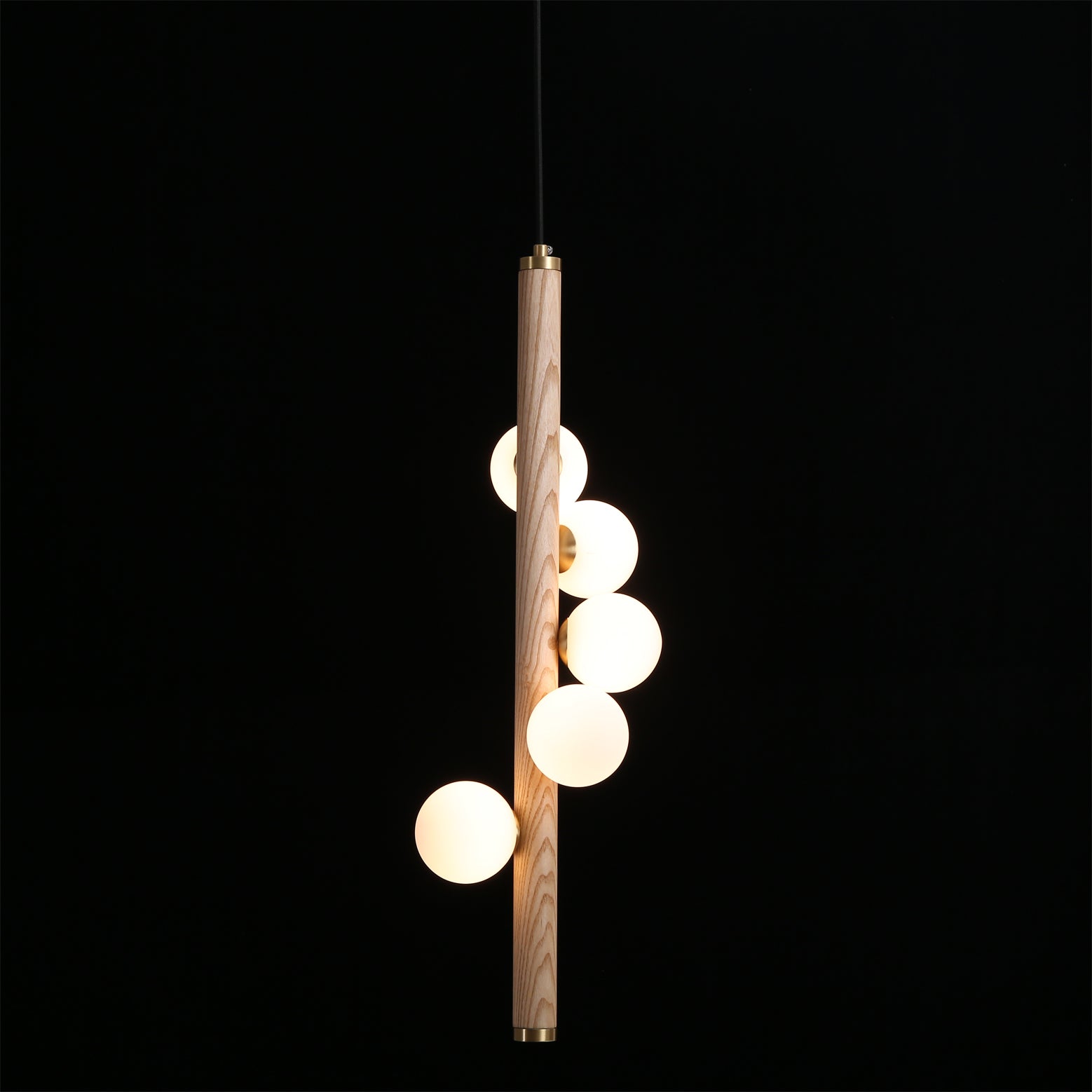 Detail of the smooth brass accents connecting the wood and glass.