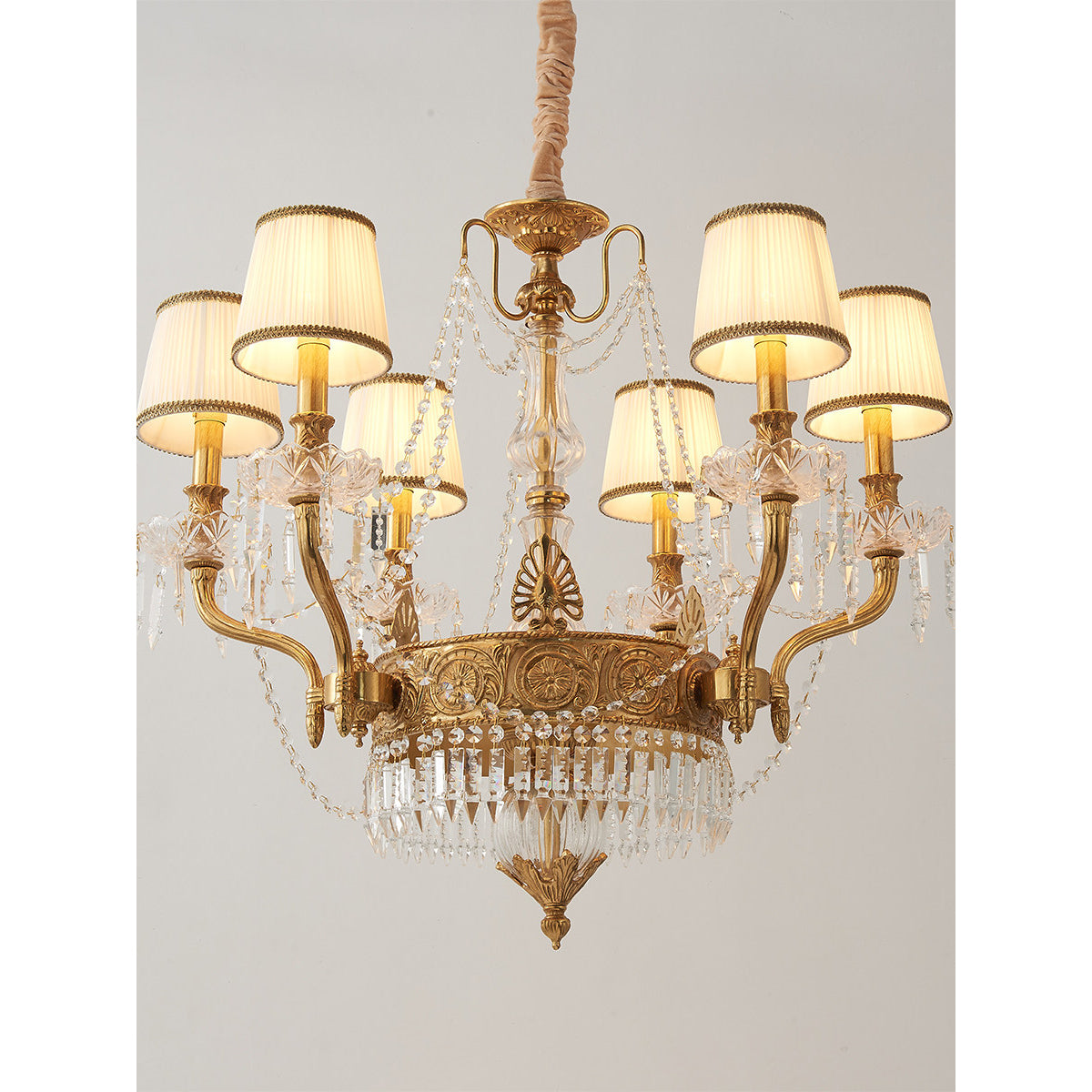 Lifestyle image of the chandelier in a luxurious master bedroom.