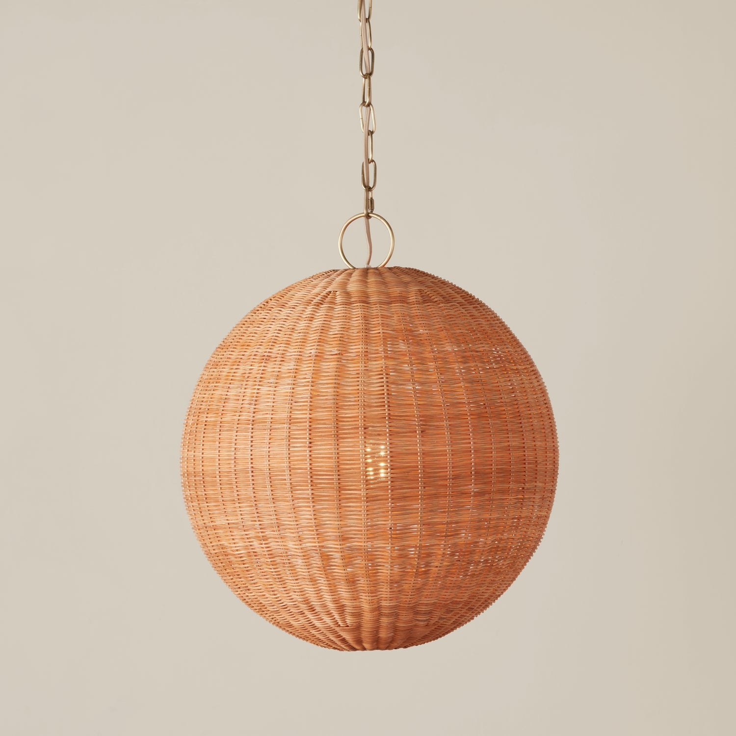 The Miramar pendant lamp unlit, highlighting its natural rattan color.