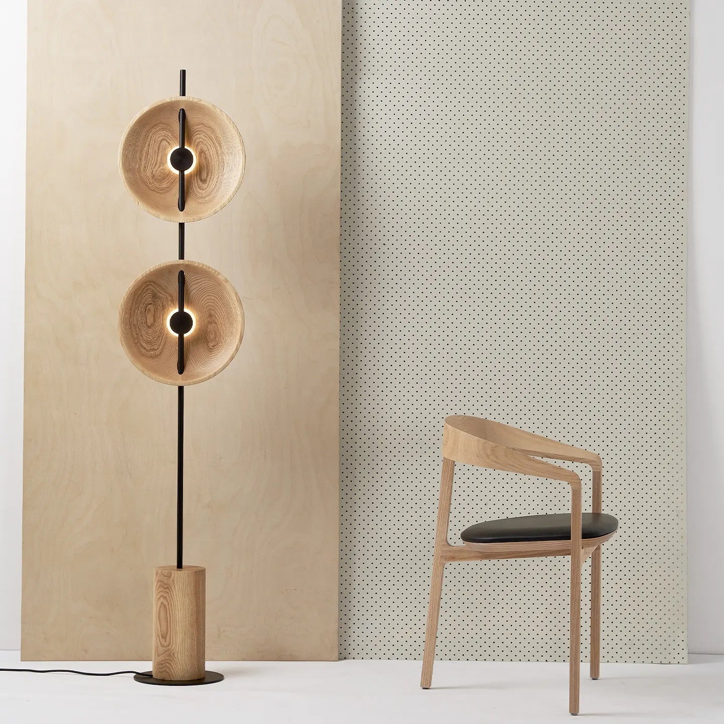 Lifestyle image of the Mito Floor Lamp next to a modern armchair.