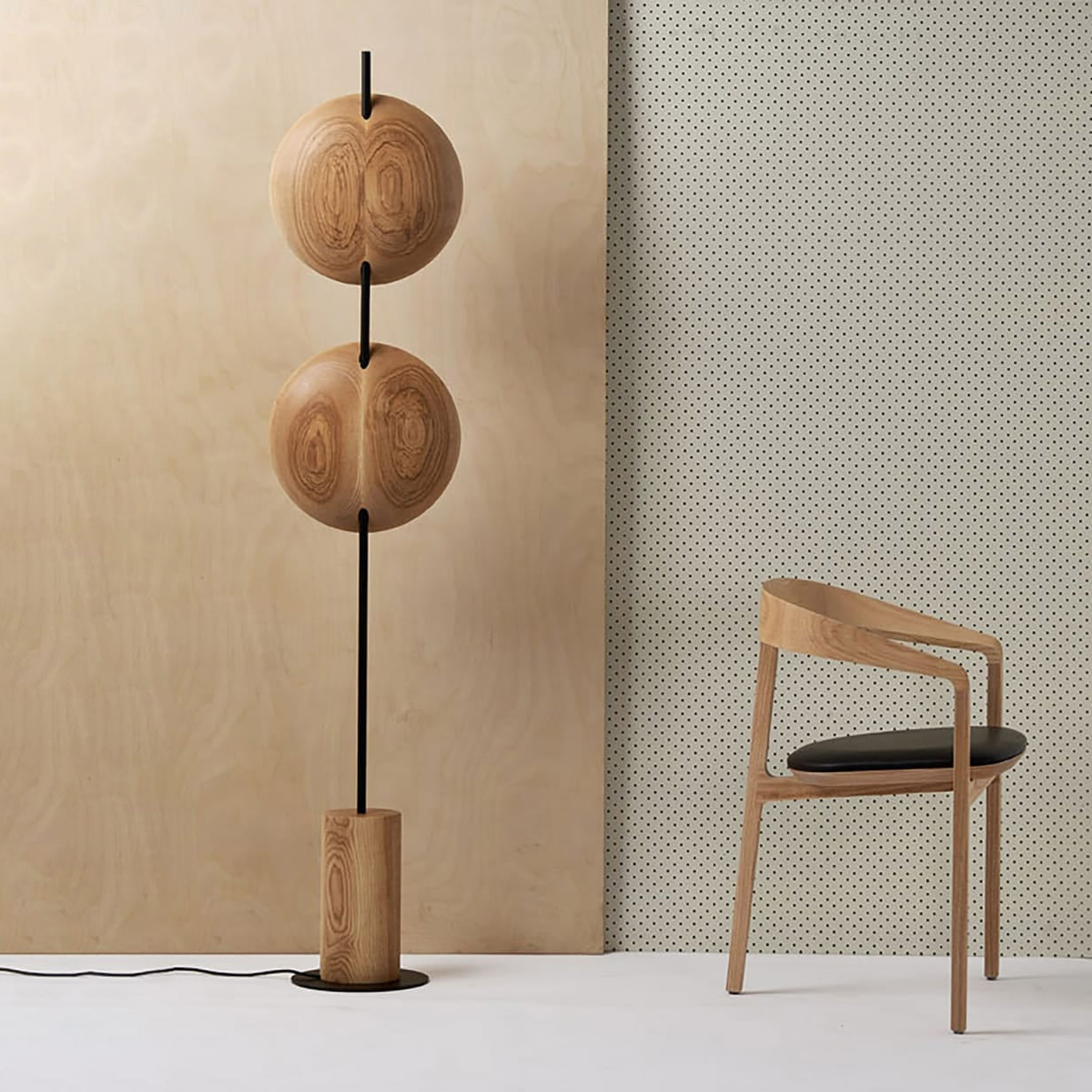 Full view of the two-headed Mito Floor Lamp against a plain wall.