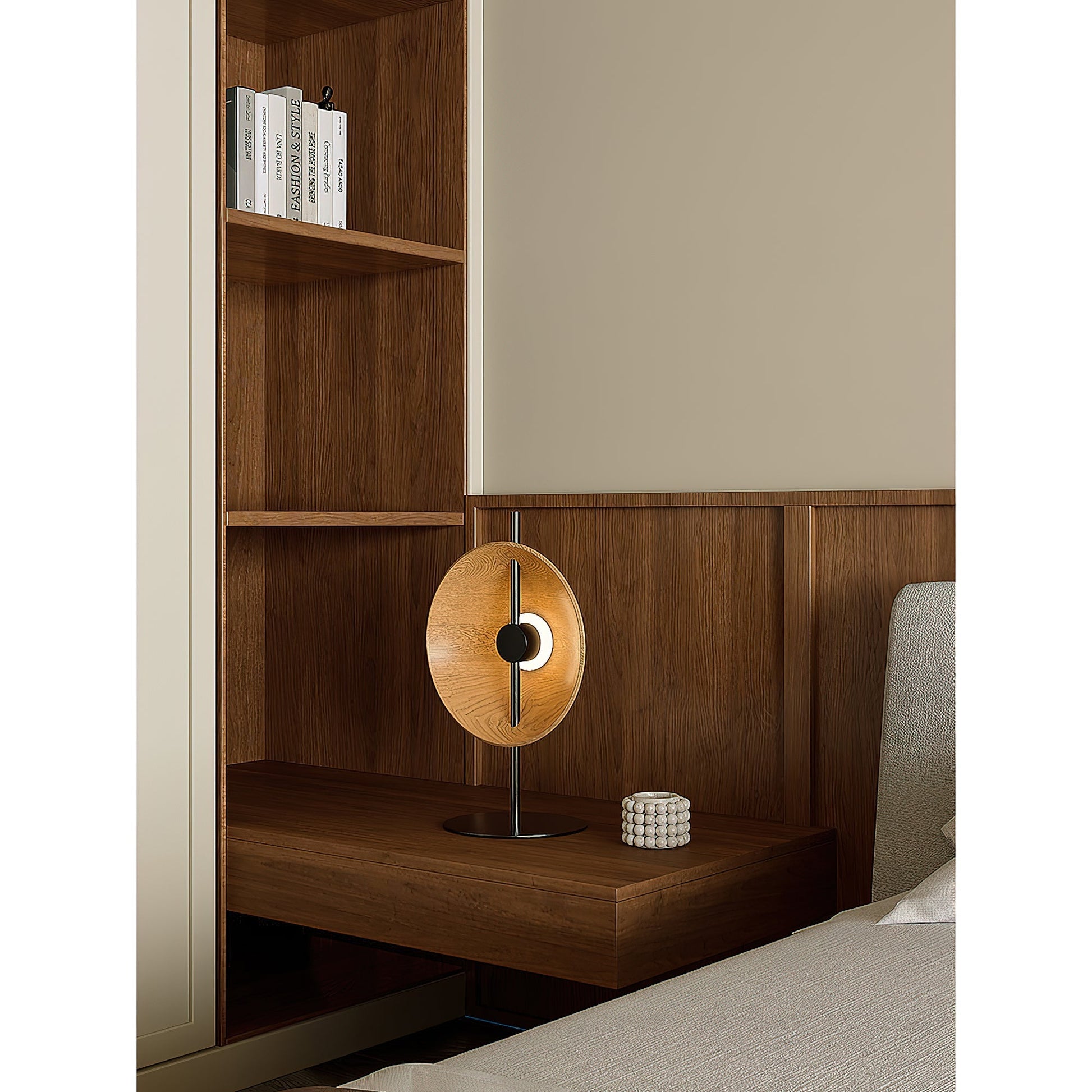 The Mito Table Lamp placed on a nightstand in a contemporary bedroom.