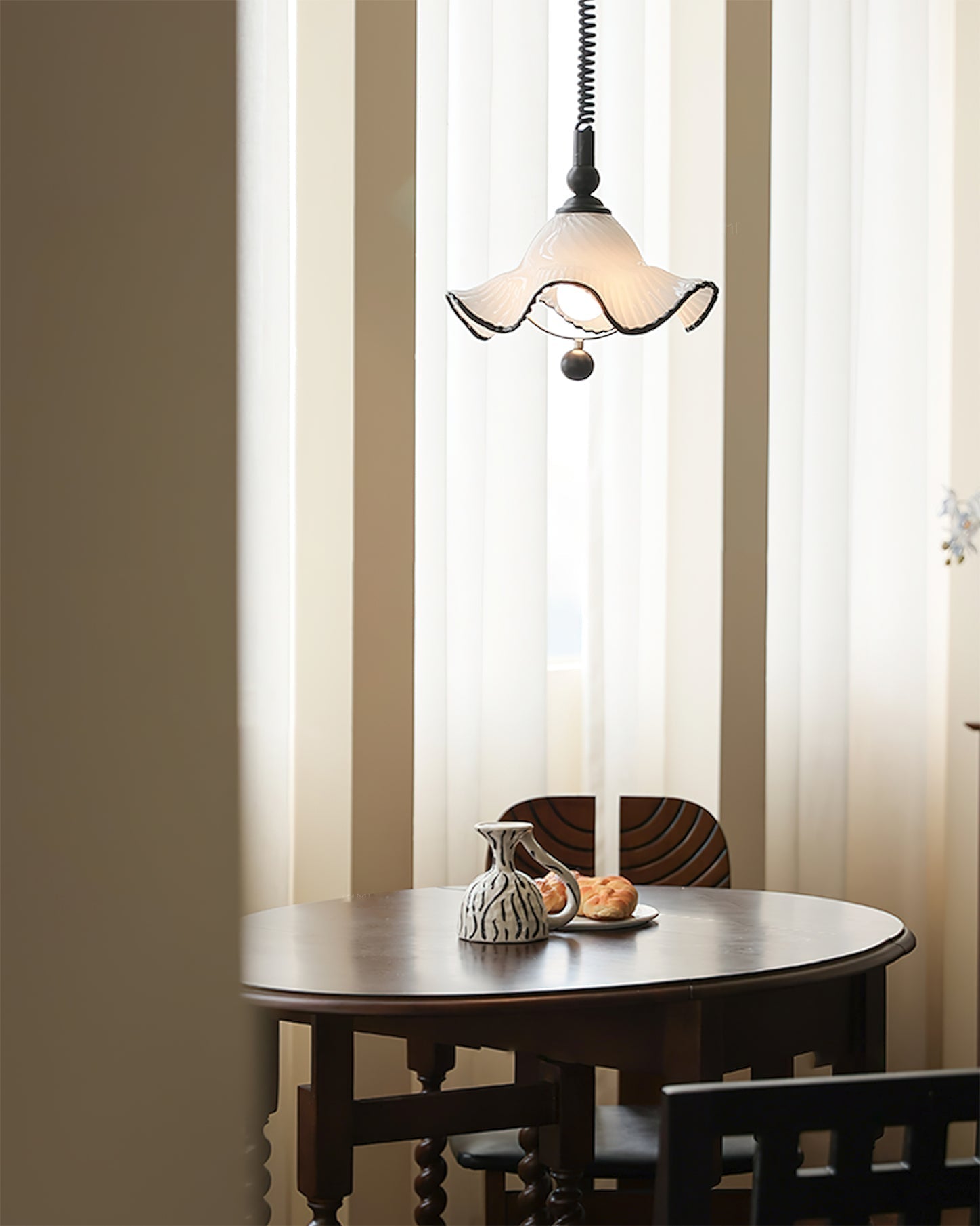 Lifestyle image of the Mobo Pendant Light in a cozy reading nook.