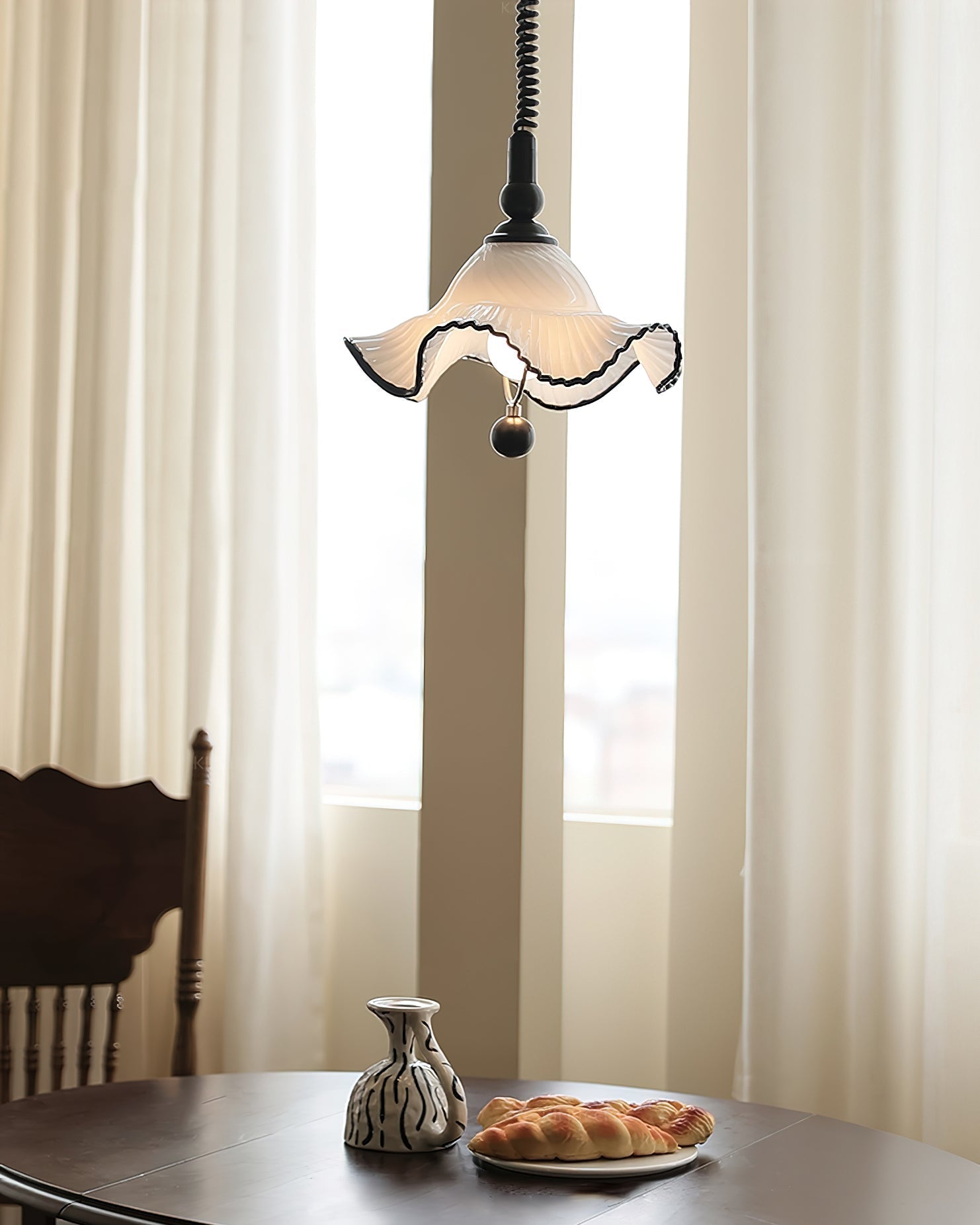A pair of Mobo Pendant Lights hanging over a kitchen island.
