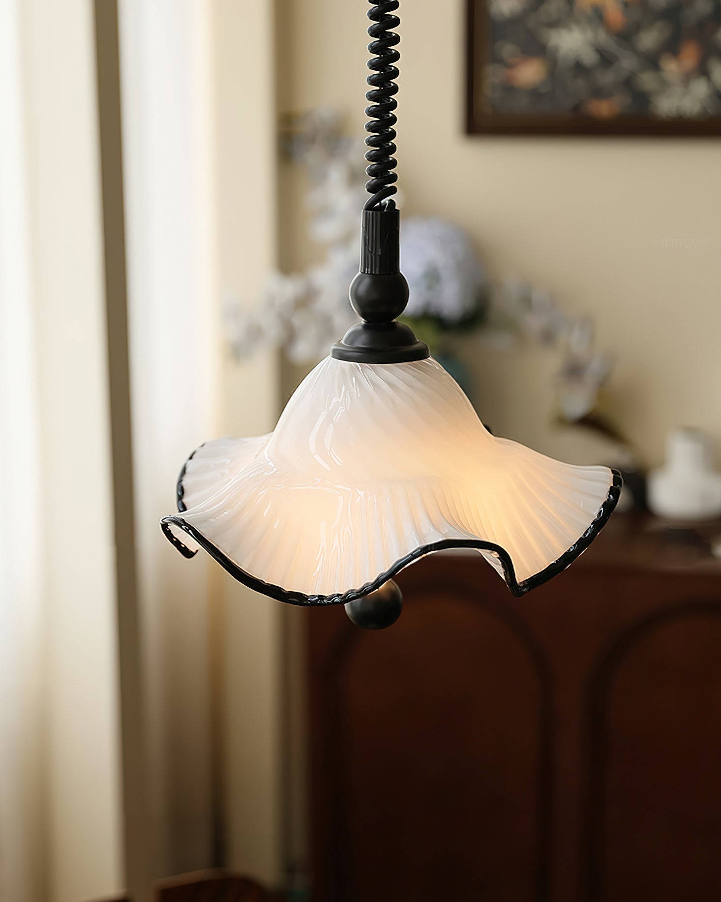 Close-up on the sleek chrome hardware of the pendant light.