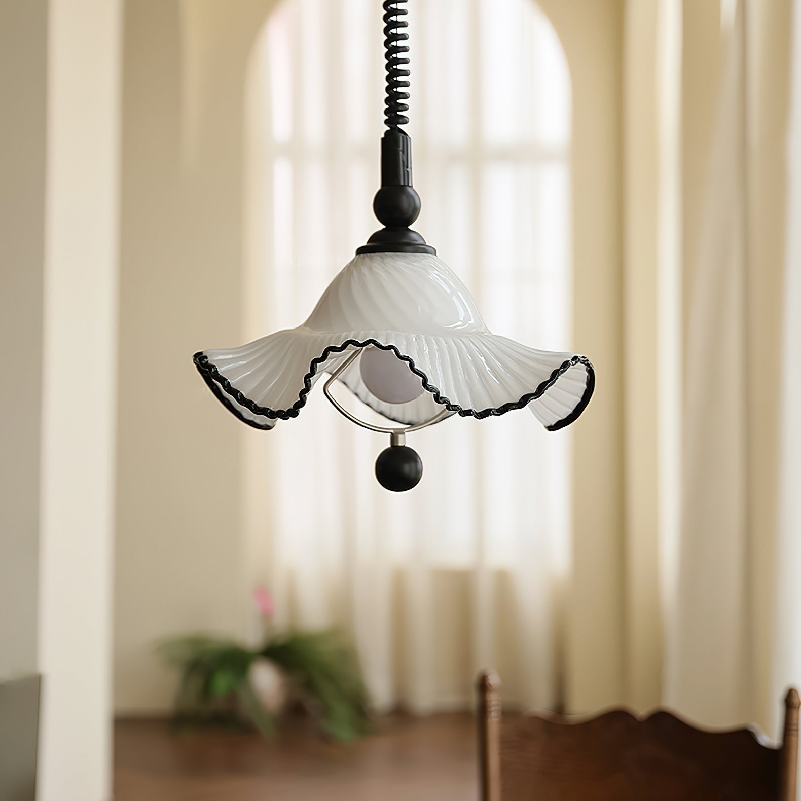 Close-up of the ruffled edge on the Mobo Pendant Light's glass shade.